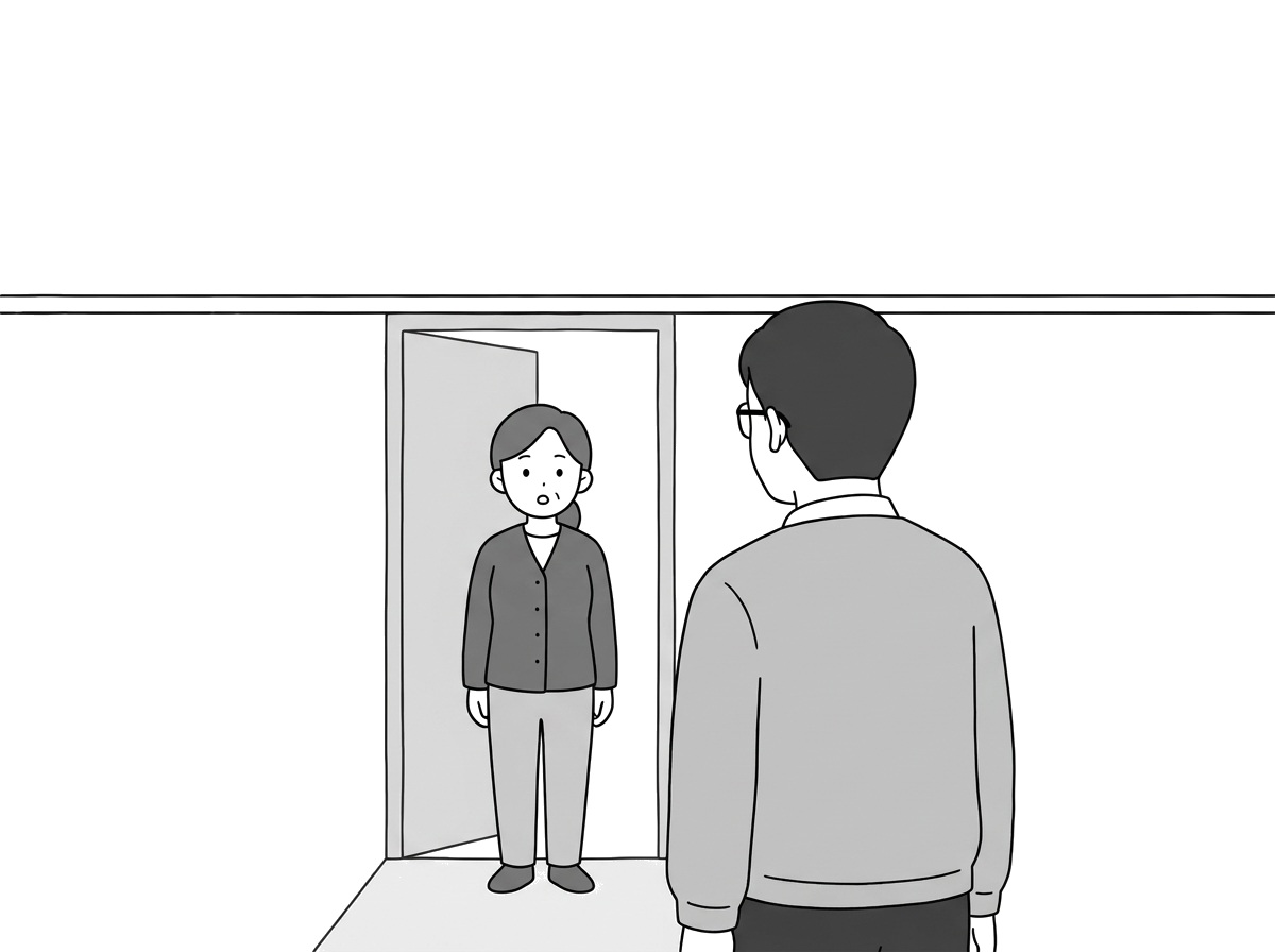 The tenant stands just inside the apartment doorway, listeni
